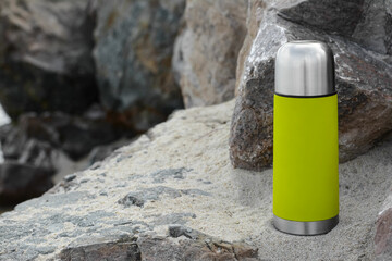 Sticker - Metallic thermos with hot drink on stone, space for text