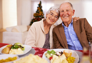 Sticker - Good food and even better company make Christmas joyous. Portrait of an affectionate senior couple on Christmas day.