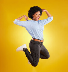 Wall Mural - Jump, muscle flex and portrait of black woman on yellow background with energy, happiness and smile in studio. Success mockup, celebration and isolated happy girl jumping for freedom, winning and joy