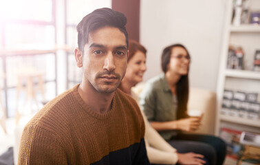 Poster - This is seriously the best spot to just chill. Portrait of a young sitting in a coffee shop with his friends blurred in the background.