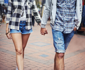 Wall Mural - Romantic stroll. Cropped image of a couple strolling hand in hand down a paved street.