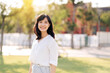 © Jirawatfoto - Portrait young beautiful asian woman with happy smile around outdoor park in sunny summer day