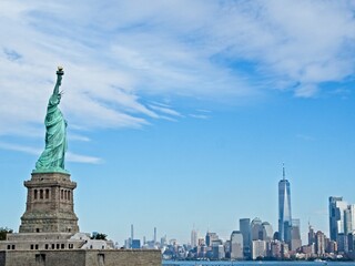 Wall Mural - The Statue of Liberty sits on Liberty Island in the New York Harbor. It was once a beacon of hope for immigrants arriving by steamship into the United States