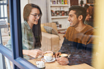 Poster - The perfect first date. a young couple sitting in a coffee shop on a date.