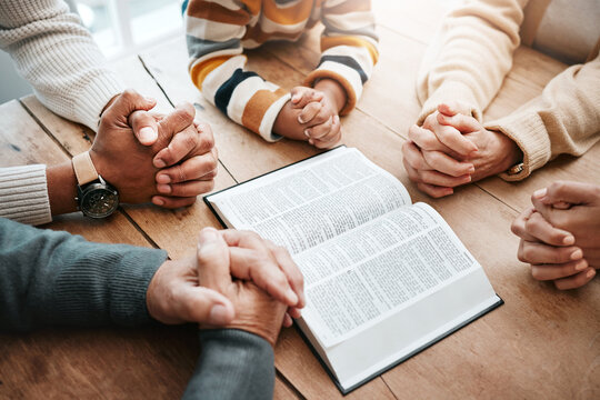 Bible, reading book or hands of big family praying for support or hope in Christian home for worship together. Mother, father or grandparents studying, prayer or asking God in religion with children