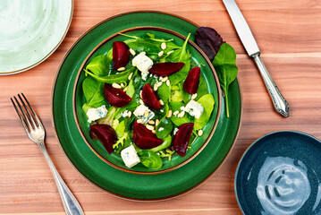 Wall Mural - Salad with beet, cheese and pine nuts,top view