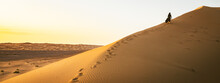 Young Beautiful Woman In Long Dress Walks Along Sand Dunes In Iran KAshan Desert