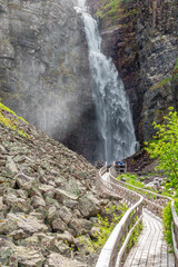 Poster - Hiking footbridge to a beautiful waterfall in a mountain canyon