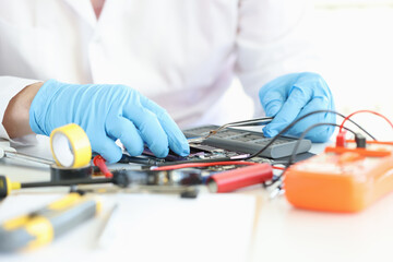 Wall Mural - Technician repairs motherboard of smartphone in laboratory