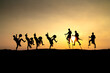 © Quang - Silhouettes of Ede boys and girls performing their traditional dance during sunset in Pleiku town, Gia Lai province, Vietnam.