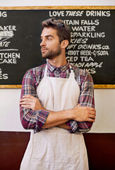 Wall Mural - Look no further for the best coffee in town. a barista standing in front of a menu written on a blackboard.