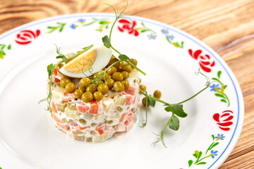 Wall Mural - russian salad on the wooden background