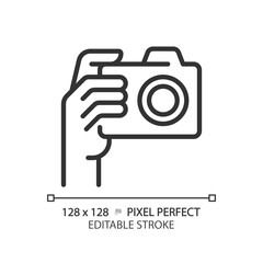 Sticker - Hand with camera pixel perfect linear icon. Person taking shot with analog equipment. Photographer tool. Thin line illustration. Contour symbol. Vector outline drawing. Editable stroke