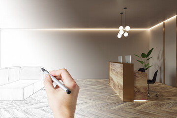 Poster - Eco office interior design project development with human hand drawing sofa by pencil, parquet floor, natural wooden reception desk with computers on light beige wall background