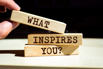 Wall Mural - Wooden blocks with words 'What Inspires You?'.