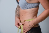 Fototapeta  - BMI index dick abnehmen dünn mager magersucht massband taille schlank frau