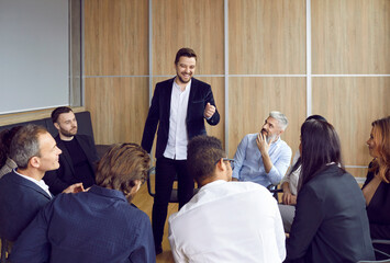 Wall Mural - Smiling male team leader head lead casual meeting with colleagues on office. Happy businessman or CEO talk at briefing with businesspeople or partners at workplace. Teamwork and leadership.