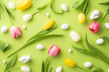 Wall Mural - Easter decorations concept. Top view photo of fresh flowers colorful tulips quail eggs and ceramic easter bunnies on isolated light green background