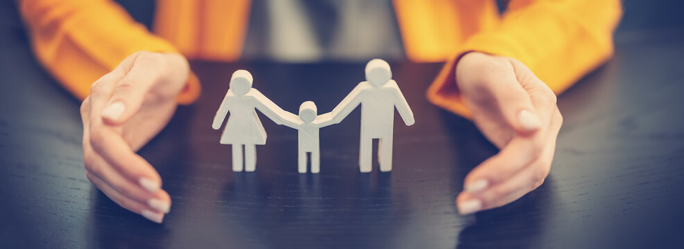 Fototapete - Figurine of the family surrounding by woman's hands.