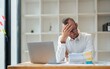© Natee Meepian - businessmen are worried about the work and the economic downturn. Tired and worried business man at workplace in office holding his head on hands