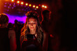 © bernardbodo - Caucasian woman using smartphone at concert
