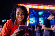 © bernardbodo - Smiling girl messaging at concert