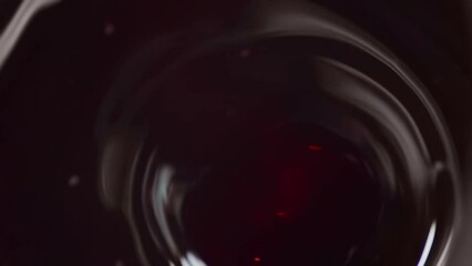 Poster - Vibrating deep wide funnel in dark red liquid with bubbles on a glare surface trembles quickly. Motion design abstraction on a dark background