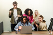 © AvokadoStudio - Happy and confident multiracial business people dancing in the office
