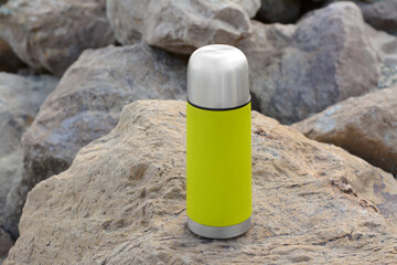 Sticker - Metallic thermos with hot drink on stone, space for text