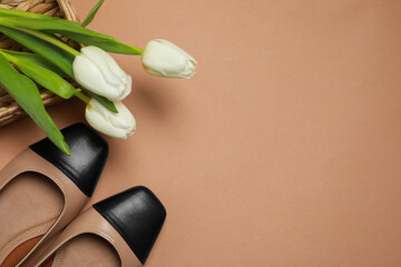 Wall Mural - Pair of new stylish square toe ballet flats and beautiful tulips on beige background, flat lay. Space for text