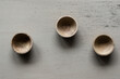 © Austockphoto - three wooden bowls on a neutral background