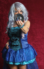 Woman Dressed as Blue Witch Holding Crystal Ball