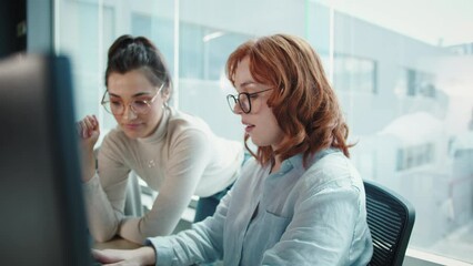 Wall Mural - Women having a discussion while working on a programming code. Business women doing a software developing project in an office. Female professionals women working in a tech.