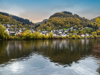 Wall Mural - Sehl village, colourful trees during autumn and reflection on Moselle river in Cochem-Zell district, Germany