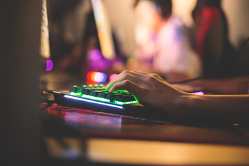 Cyber sport e-sports tournament, team of professional gamers, gamer's hands on mouse and keyboard, pushing button, gamers playing in competitive moba, strategy fps game in a cyber games arena club