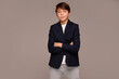 © neonshot - Elegant, fashionable and confident teen boy posing in studio, looking at the camera