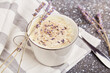 Stylish aesthetic lavender coffee with flowers close up
