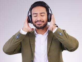 Poster - Music, relax and headphones with a business man in studio on a gray background streaming audio. Peace, quiet and calm with a male employee listening to the radio during a mental health break