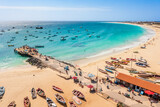 Fototapeta  - Pier and boats on turquoise water in city of Santa Maria, Sal, Cape Verde