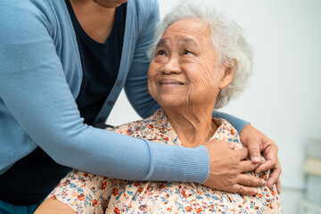 Caregiver help Asian elderly woman patient with love, care, encourage and empathy at nursing hospital, healthy strong medical concept.