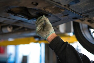 Wall Mural - car workshop, car oil change in a garage by a car mechanic