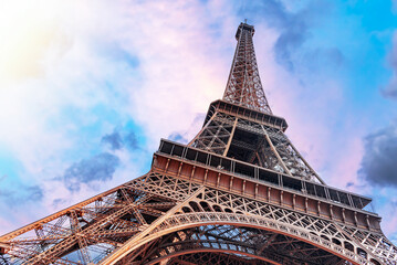 The Eiffel Tower in Paris against the backdrop of a beautiful evening sky.