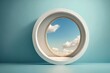 a circular window looks out into the sky with clouds in the window