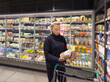 © lado2016 - supermarket shopping,Woman choosing a dairy products at supermarket.