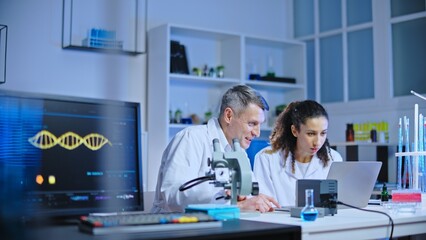 Excited lab scientists looking at results of dna analysis, successful genetic research