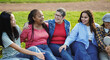 Happy multiracial women having fun together at city park - Multi generational female friendship concept