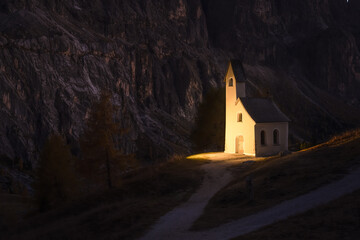 Wall Mural - Incredible view on small iIlluminated chapel - Kapelle Ciapela on Gardena Pass, Italian Dolomites mountains. Dolomite Alps, Italy. Landscape photography