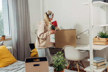 A college student is unpacking her stuff from boxes