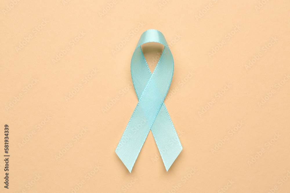 Blue awareness ribbon on color background. Prostate cancer concept