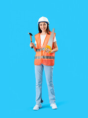 Sticker - Female worker in vest and with tools on blue background